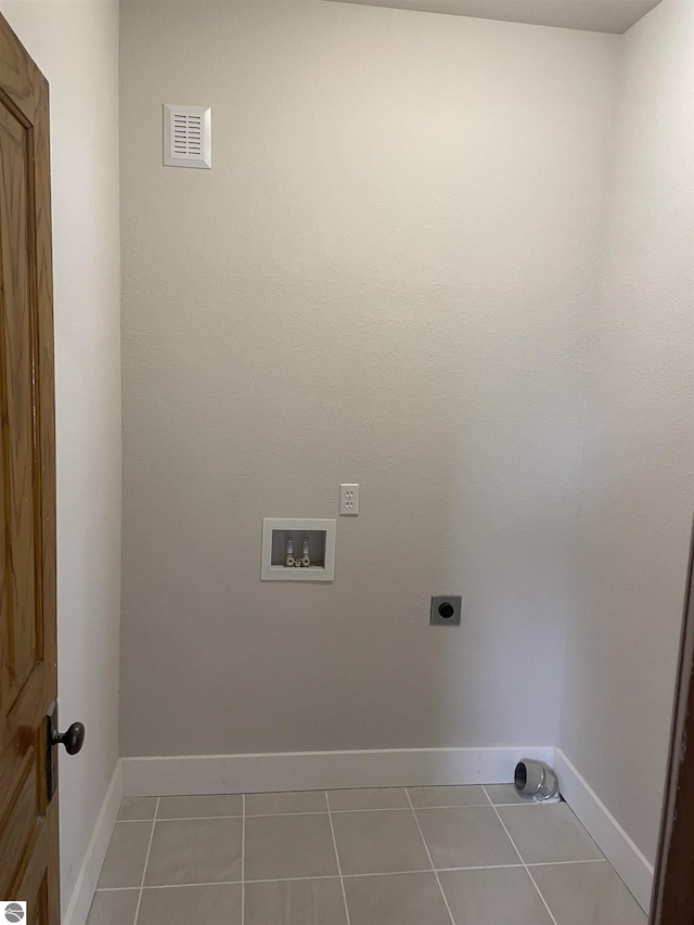 clothes washing area with washer hookup, light tile patterned floors, visible vents, hookup for an electric dryer, and laundry area