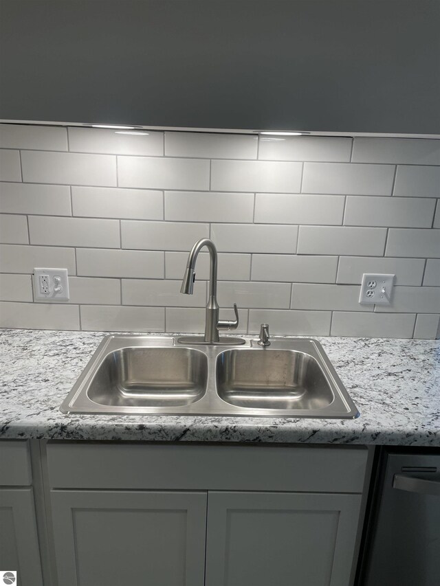 309 E Wisconsin, Mount Pleasant, MI 48858 - kitchen view of a sink, tasteful backsplash, and light countertops