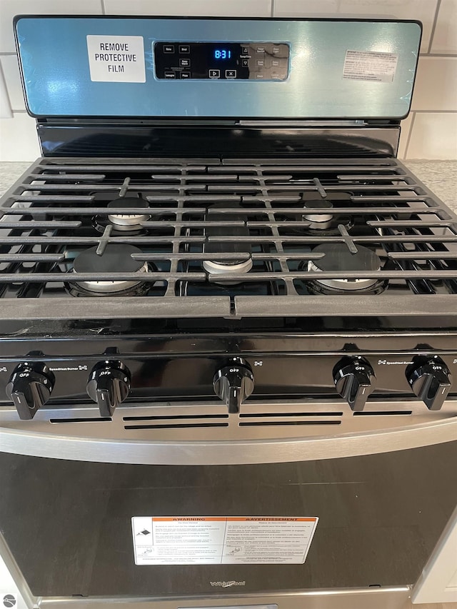 309 E Wisconsin, Mount Pleasant, MI 48858 - detailed view of stainless steel gas stove and tasteful backsplash