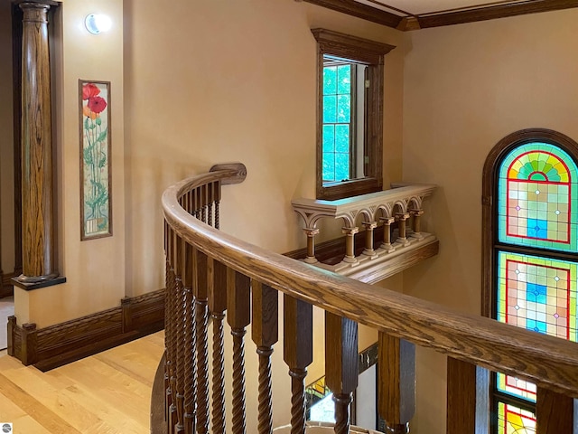 stairs featuring crown molding and hardwood / wood-style flooring