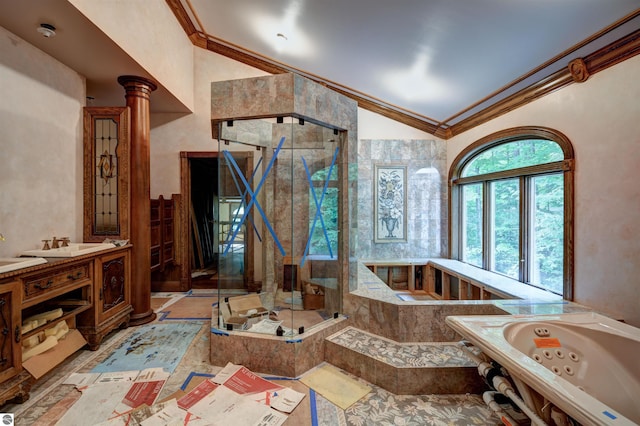 bathroom featuring decorative columns, lofted ceiling, shower with separate bathtub, vanity, and ornamental molding