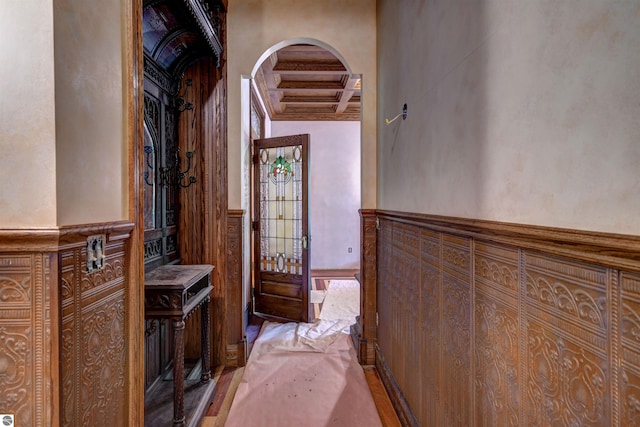 hall featuring beamed ceiling and coffered ceiling