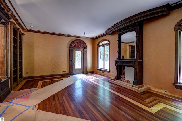 entrance foyer featuring wood-type flooring and ornamental molding