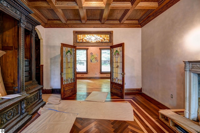 foyer entrance featuring coffered ceiling, ornamental molding, and french doors