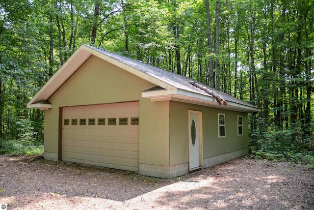 view of front of property with a garage and an outdoor structure