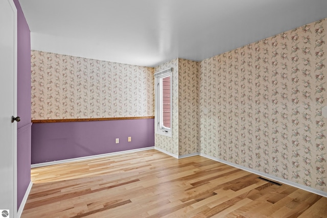 spare room featuring hardwood / wood-style floors