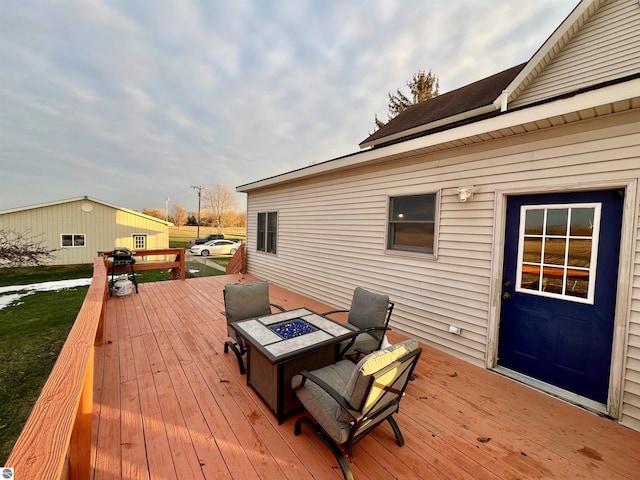 wooden deck featuring a fire pit