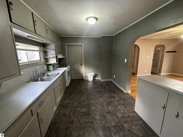 kitchen with ventilation hood, white gas stove, ceiling fan, and sink