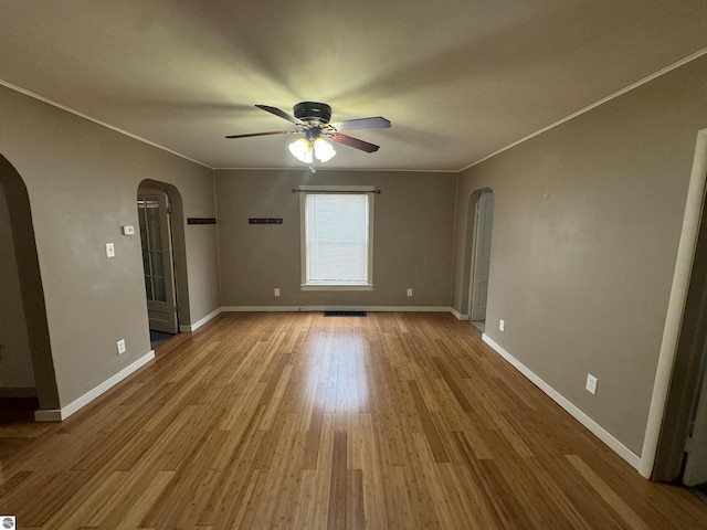 unfurnished room featuring wood-type flooring, ceiling fan, and crown molding