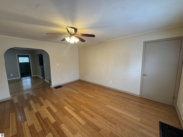 spare room with ceiling fan and light wood-type flooring