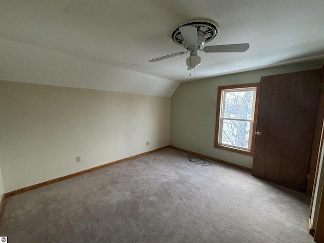 bonus room featuring ceiling fan, light colored carpet, and vaulted ceiling