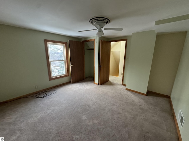 unfurnished bedroom with light colored carpet and ceiling fan