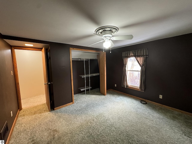 unfurnished bedroom with carpet flooring, ceiling fan, and a closet