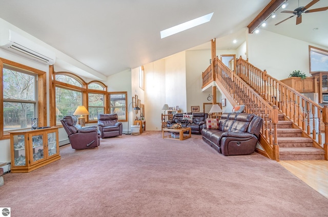 living room with beam ceiling, a skylight, ceiling fan, high vaulted ceiling, and a wall unit AC