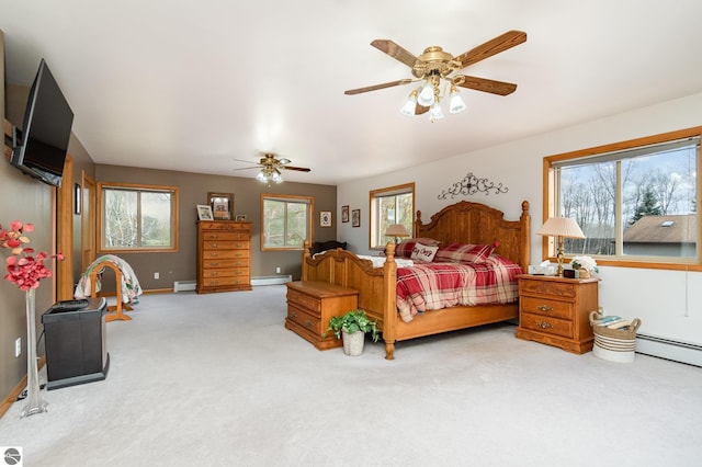 bedroom featuring baseboard heating, ceiling fan, and light colored carpet