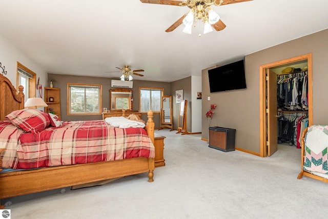 bedroom with ceiling fan, light colored carpet, a spacious closet, and a closet