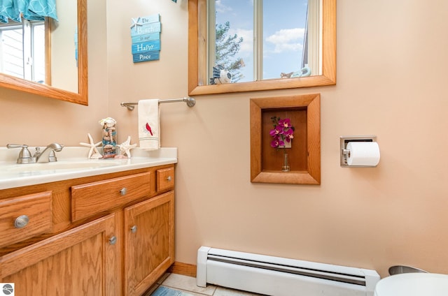 bathroom featuring tile patterned flooring, vanity, and a baseboard heating unit