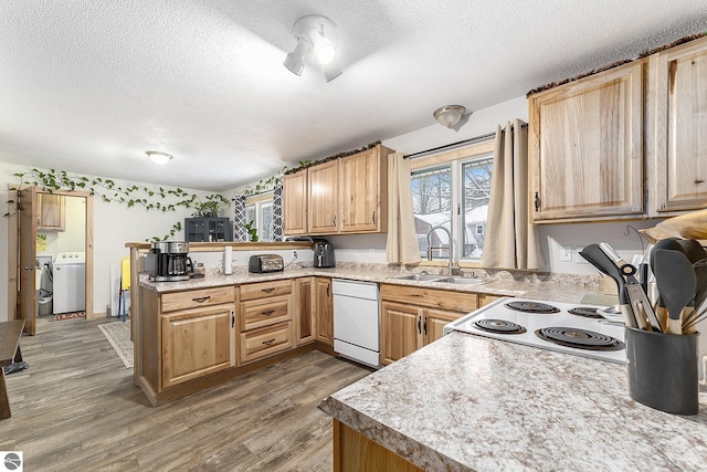 kitchen with white appliances, sink, dark hardwood / wood-style floors, a textured ceiling, and washer / dryer