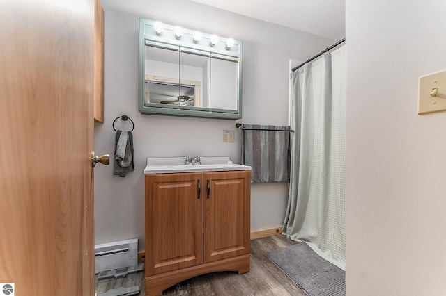 bathroom with curtained shower, vanity, and wood-type flooring