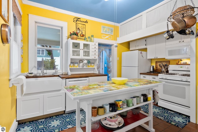 kitchen featuring open shelves, a sink, white cabinetry, and white appliances