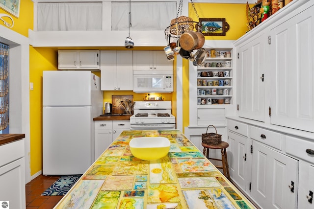 kitchen with wooden counters, open shelves, white appliances, dark tile patterned flooring, and white cabinetry