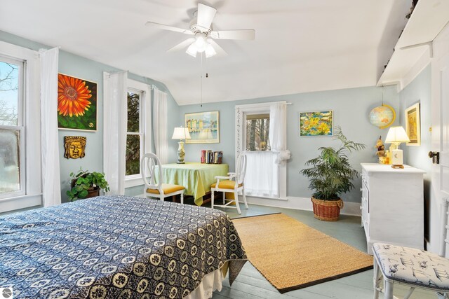 bedroom with lofted ceiling, a ceiling fan, and baseboards