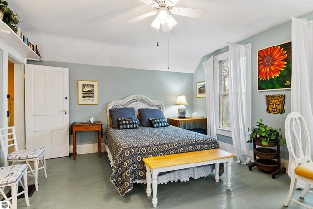 bedroom with vaulted ceiling, ceiling fan, and wood finished floors