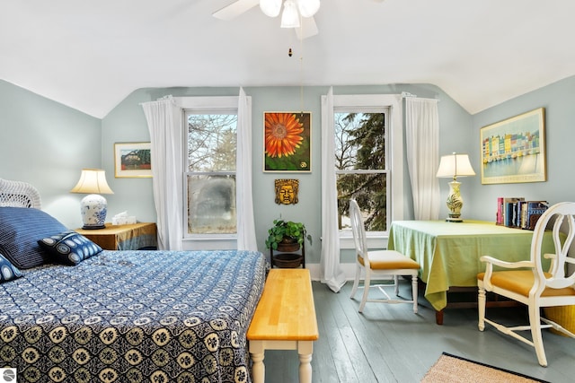 bedroom featuring wood-type flooring, vaulted ceiling, and multiple windows