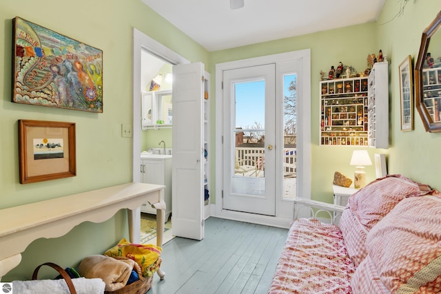 doorway to outside featuring hardwood / wood-style floors and a sink