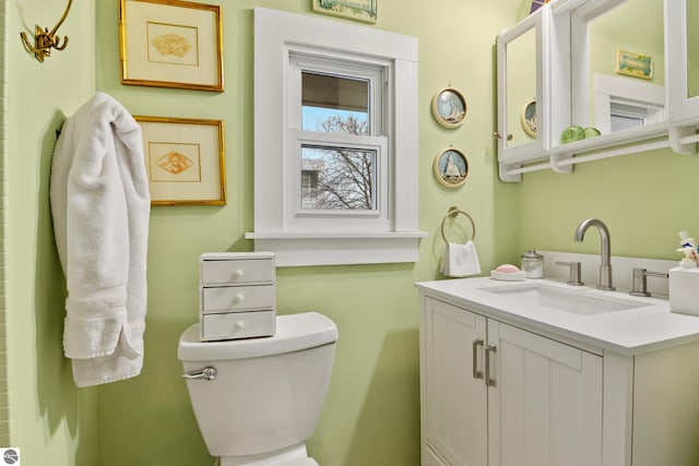 bathroom featuring toilet and vanity
