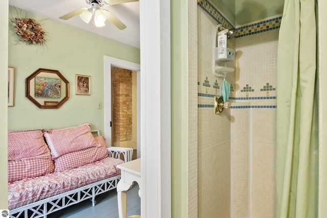 full bath with a ceiling fan and tiled shower