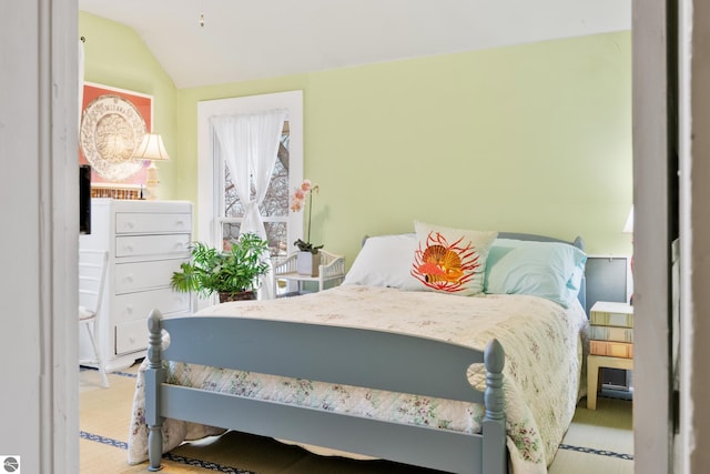 carpeted bedroom featuring vaulted ceiling