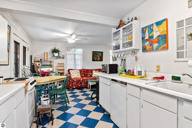 kitchen featuring a sink, a ceiling fan, white appliances, light floors, and light countertops