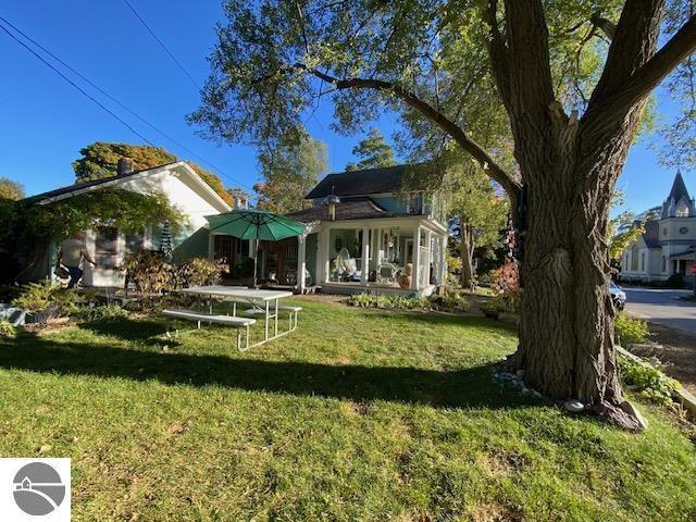 rear view of property featuring a lawn