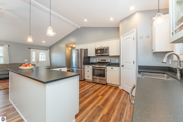 kitchen featuring appliances with stainless steel finishes, dark hardwood / wood-style flooring, white cabinetry, and sink