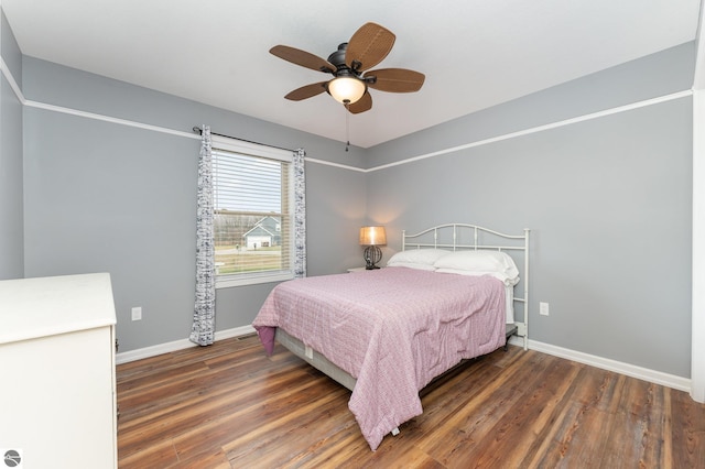 bedroom with ceiling fan and dark wood-type flooring