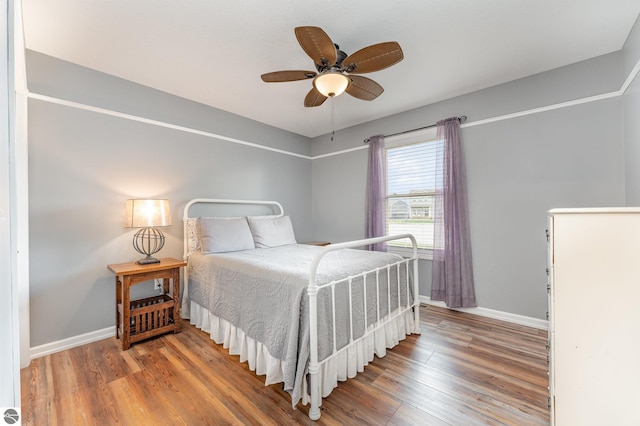 bedroom featuring hardwood / wood-style floors and ceiling fan