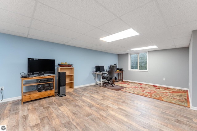 office area with hardwood / wood-style floors and a drop ceiling