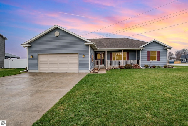 ranch-style house with a porch, a yard, and a garage