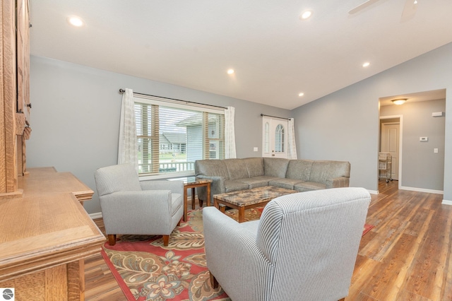 living room featuring light wood-type flooring, ceiling fan, and lofted ceiling