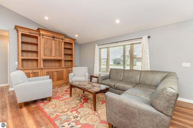 living room featuring light hardwood / wood-style floors and lofted ceiling