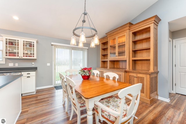 dining area featuring a notable chandelier and dark wood-type flooring