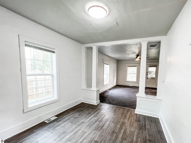 interior space with decorative columns, ceiling fan, and hardwood / wood-style floors