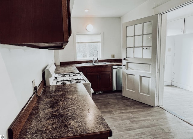 kitchen featuring sink, stainless steel dishwasher, wood-type flooring, white range with gas cooktop, and dark brown cabinets