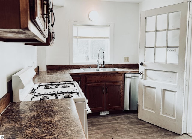 kitchen with dishwasher, dark hardwood / wood-style floors, white range with gas cooktop, and sink