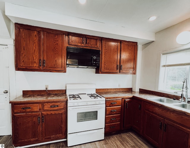 kitchen with white gas range, dark wood-type flooring, and sink