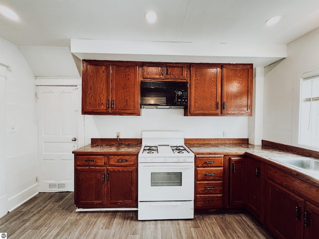 kitchen featuring hardwood / wood-style flooring and white range