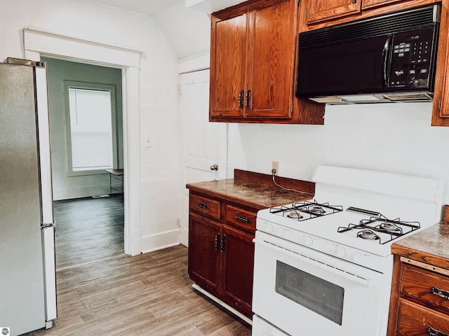 kitchen featuring light hardwood / wood-style floors and white appliances