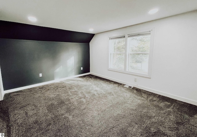 bonus room with carpet floors and lofted ceiling