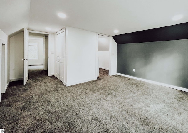 bonus room featuring dark carpet and lofted ceiling